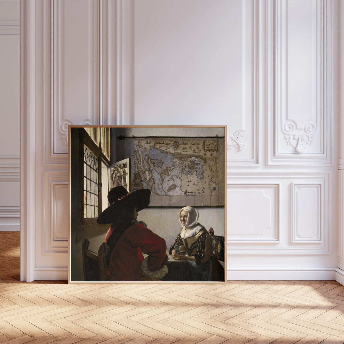 Framed art print of Officer and Laughing Girl by Johannes Vermeer, leaning against pale pink panelling on a herringbone floor