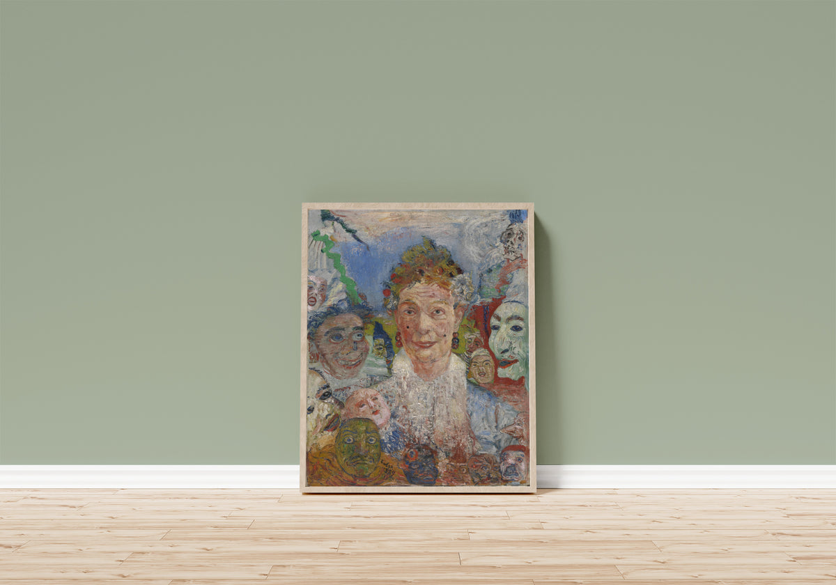 Framed art print of Old Lady with Masks by James Ensor, in a light wood frame leaning on a sage green wall above a wooden floor