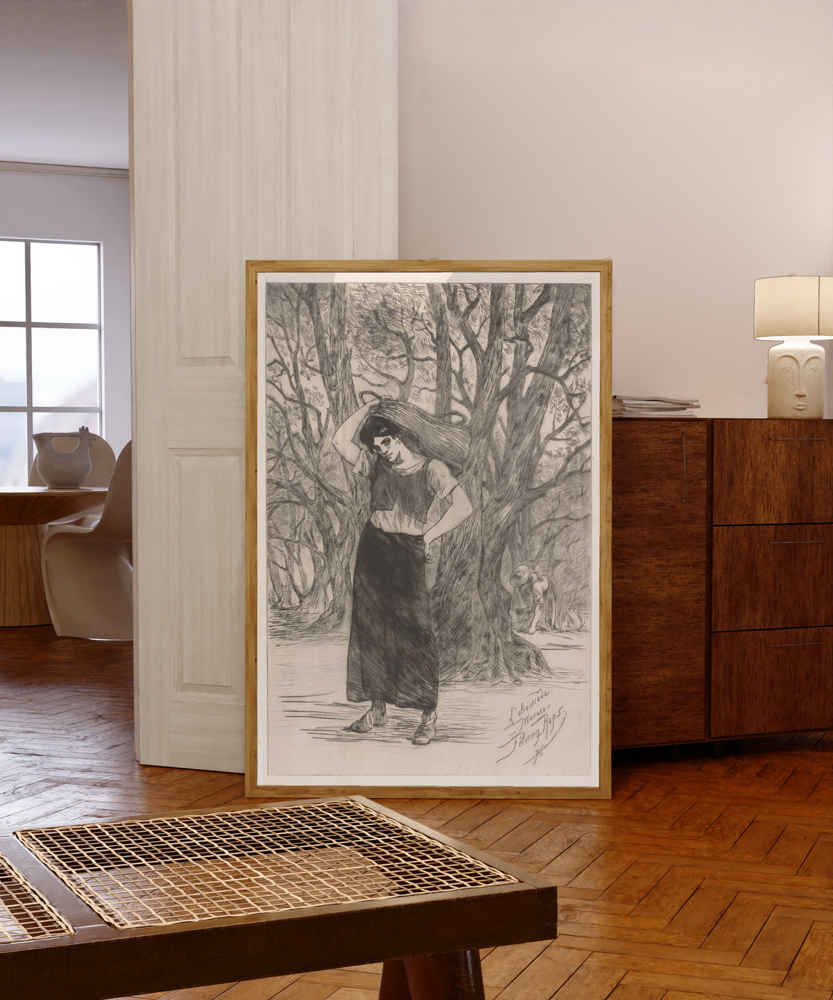 Framed art print of Olijvenplukster (L'olivierade, À Monaco) by Félicien Rops, in a light wood frame leaning in a warm room with a parquet floor