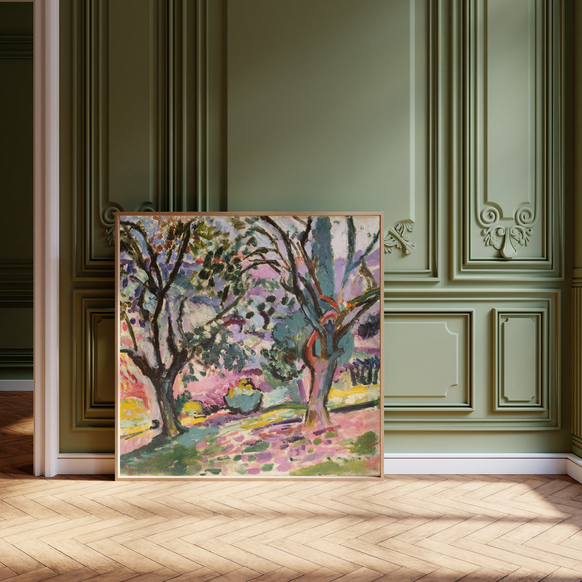 Framed art print of Olive Trees at Collioure by Henri Matisse, leaning against olive-green panelling on a herringbone floor