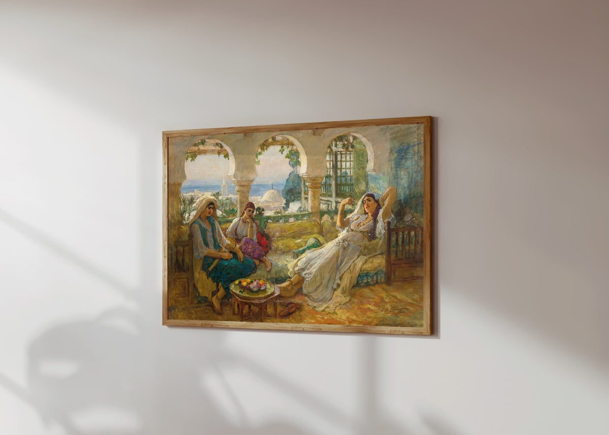 Framed art print of On the Terrace by Frederick Arthur Bridgman, in a light wood frame on a sunlit white wall, seen at a slight angle