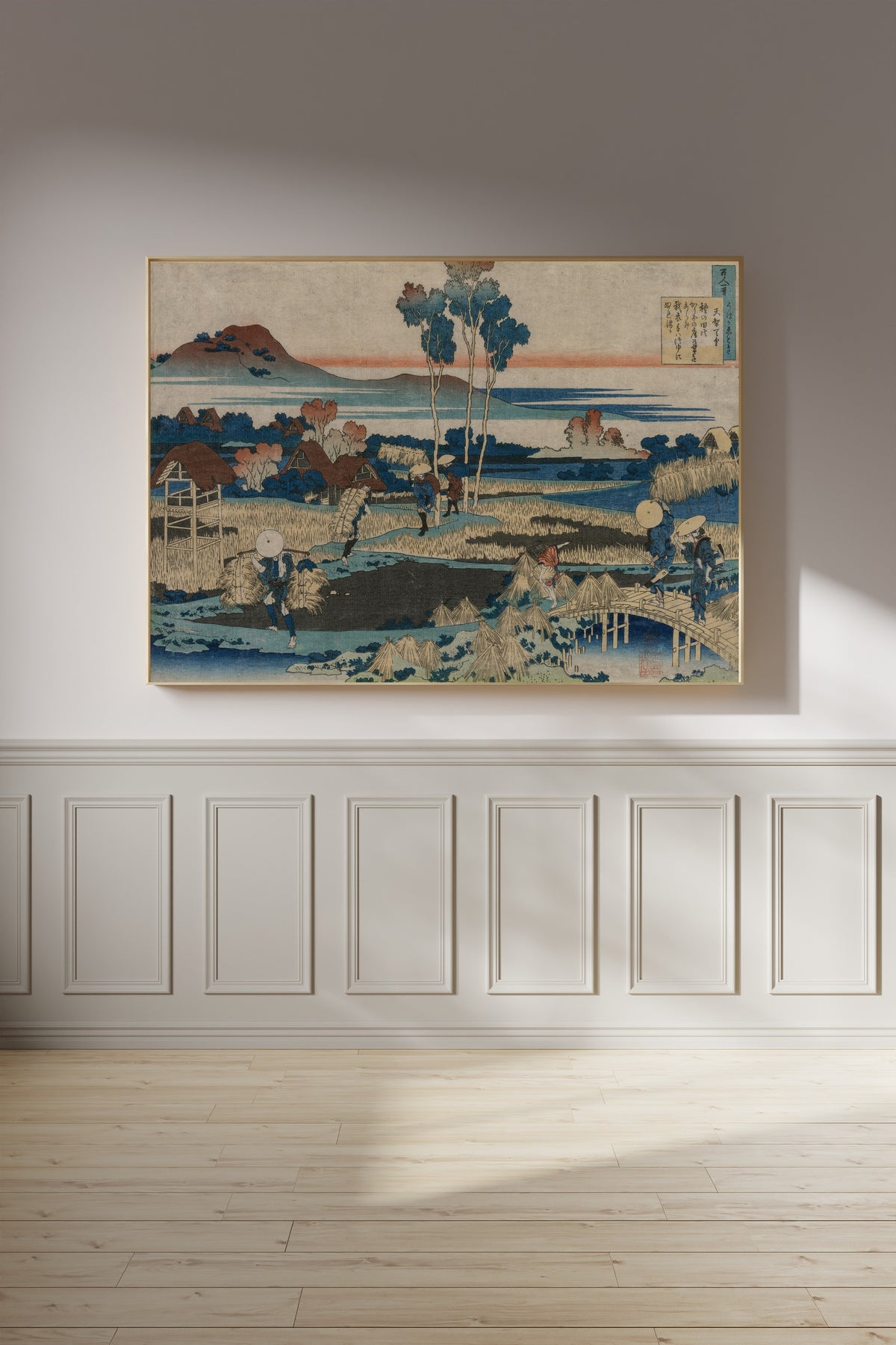 Framed art print of One Hundred Poems Explained by the Nurse: Poem by Emperor Tenchi by Katsushika Hokusai, on a panelled wall in afternoon light