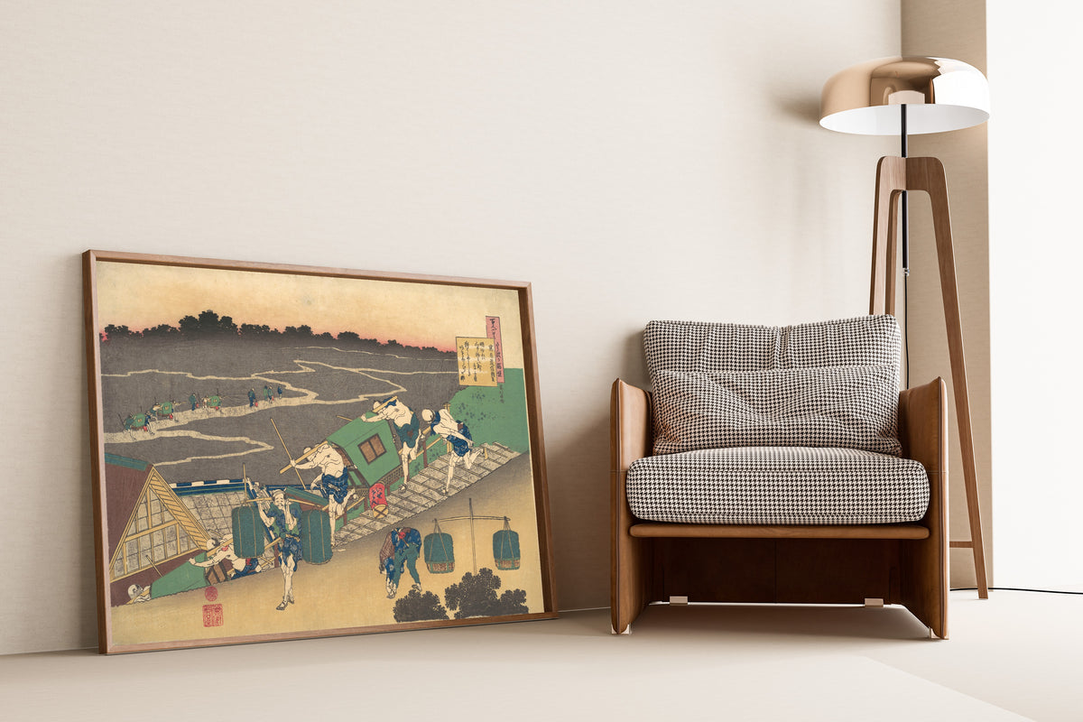 Framed art print of One Hundred Poems Explained by the Nurse: Poem by… by Katsushika Hokusai, leaning against a wall beside an armchair and a floor lamp