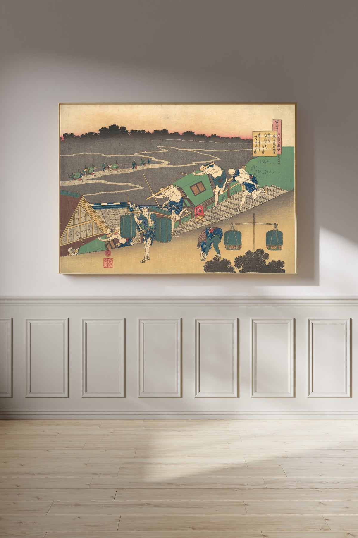 Framed art print of One Hundred Poems Explained by the Nurse: Poem by Fujiwara no Michinobu Ason by Katsushika Hokusai, on a panelled wall in afternoon light