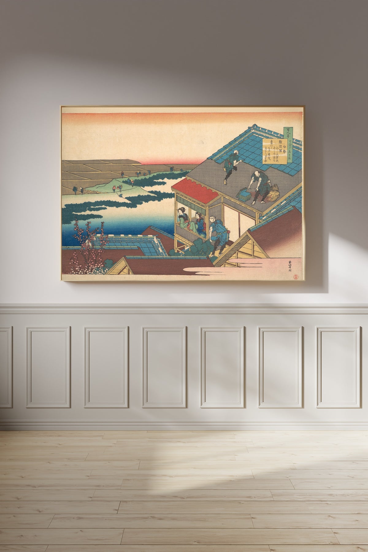 Framed art print of One Hundred Poems Explained by the Nurse: Poem by Ise by Katsushika Hokusai, on a panelled wall in afternoon light