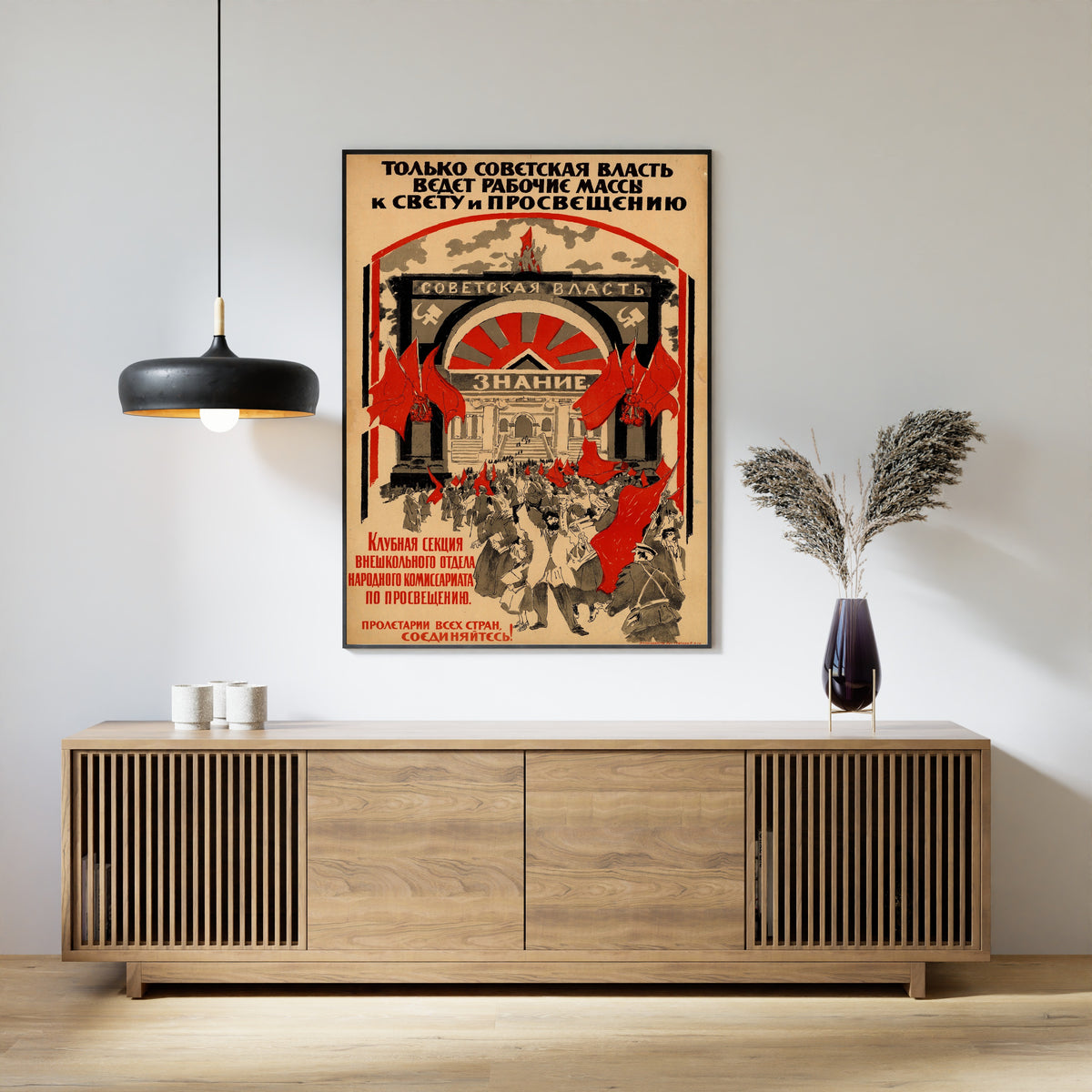 Framed art print of Only Soviet Power Leads the Working Masses to Light and Enlightenment, above a slatted wood sideboard