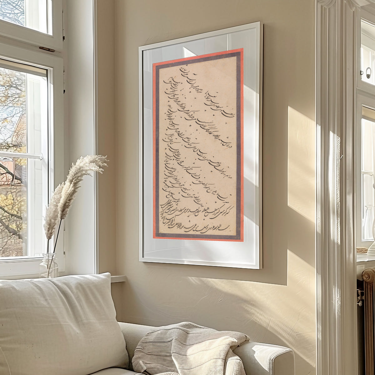 Framed art print of Page of Calligraphy by Abd al-Majid Taleqani, in a sunlit living room above a sofa