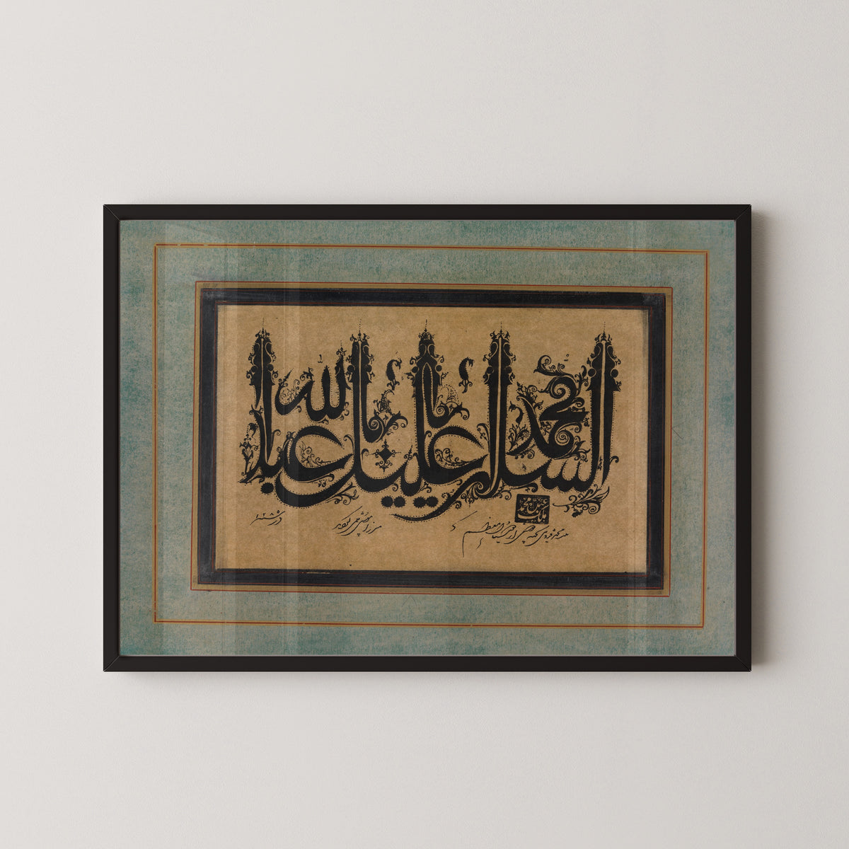 Framed art print of Page of Calligraphy in Ornamental Style by Malik Muhammad Qazvini, in a black frame on a pale wall