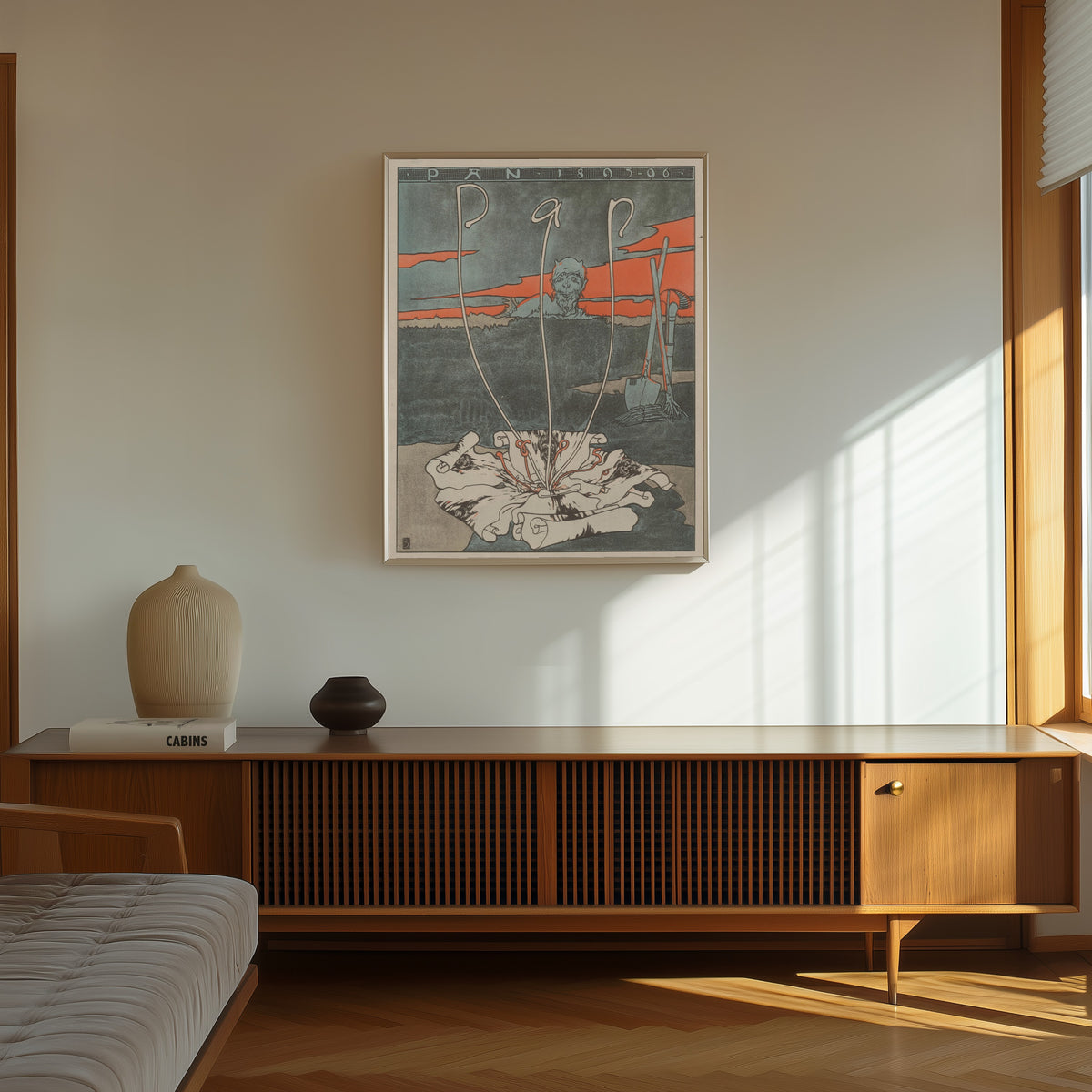Framed art print of Pan by Joseph Sattler, in a thin light frame on a sunlit wall above a wooden sideboard
