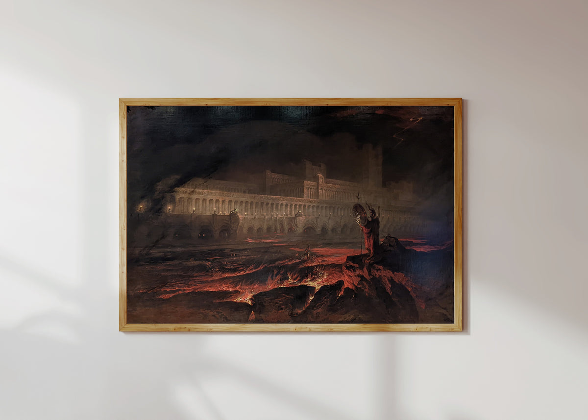 Framed art print of Pandemonium by John Martin, in a light wood frame on a sunlit white wall