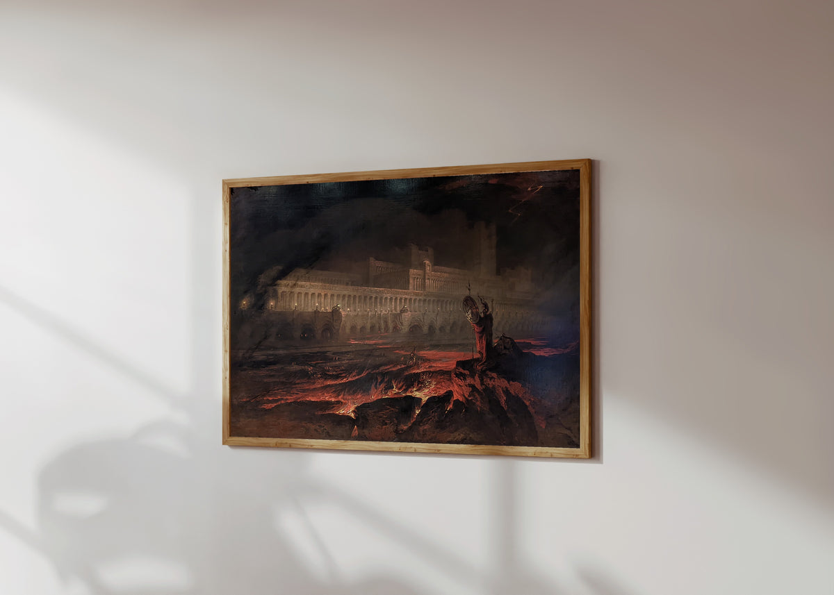 Framed art print of Pandemonium by John Martin, in a light wood frame on a sunlit white wall, seen at a slight angle