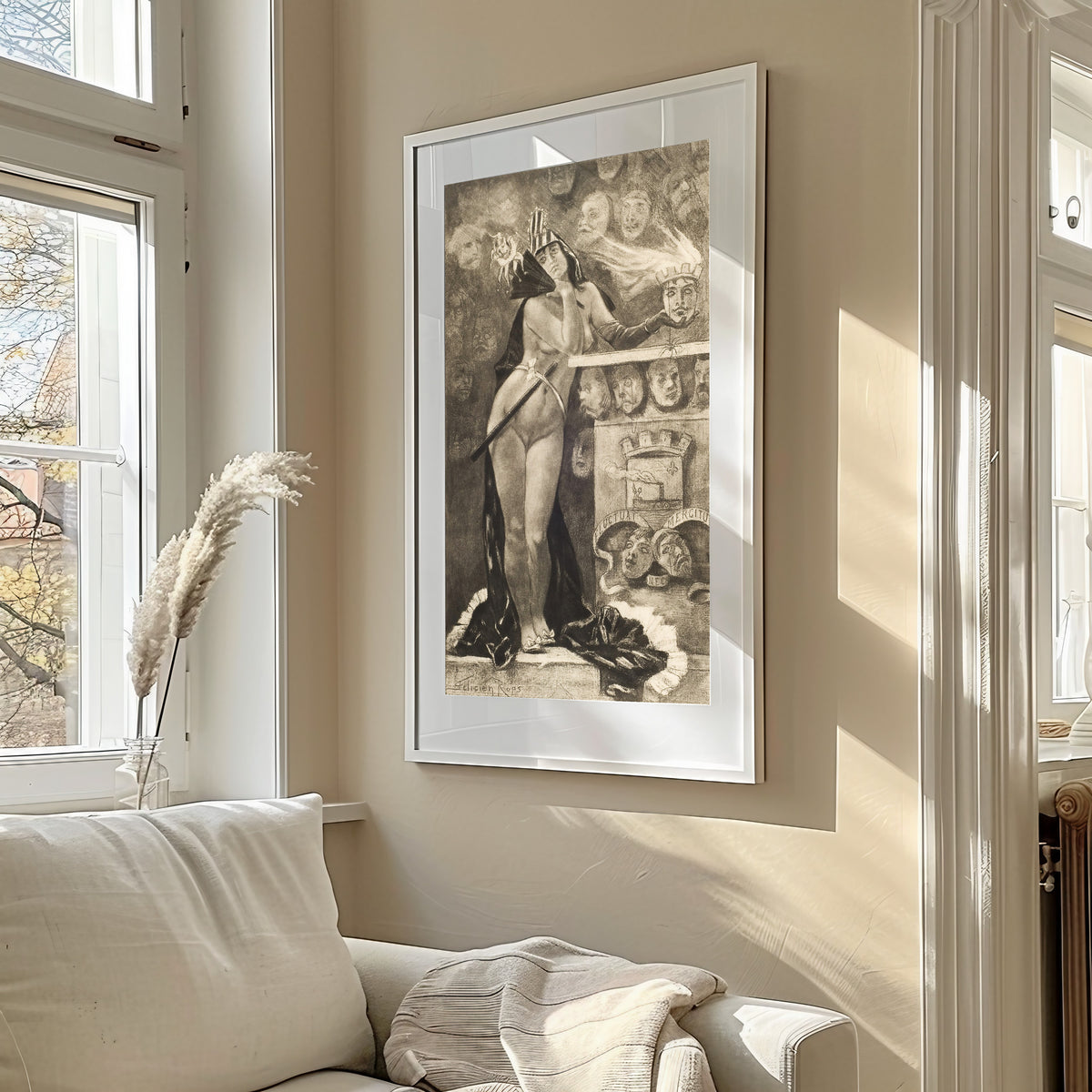Framed art print of Parisian Masks by Félicien Rops, in a sunlit living room above a sofa