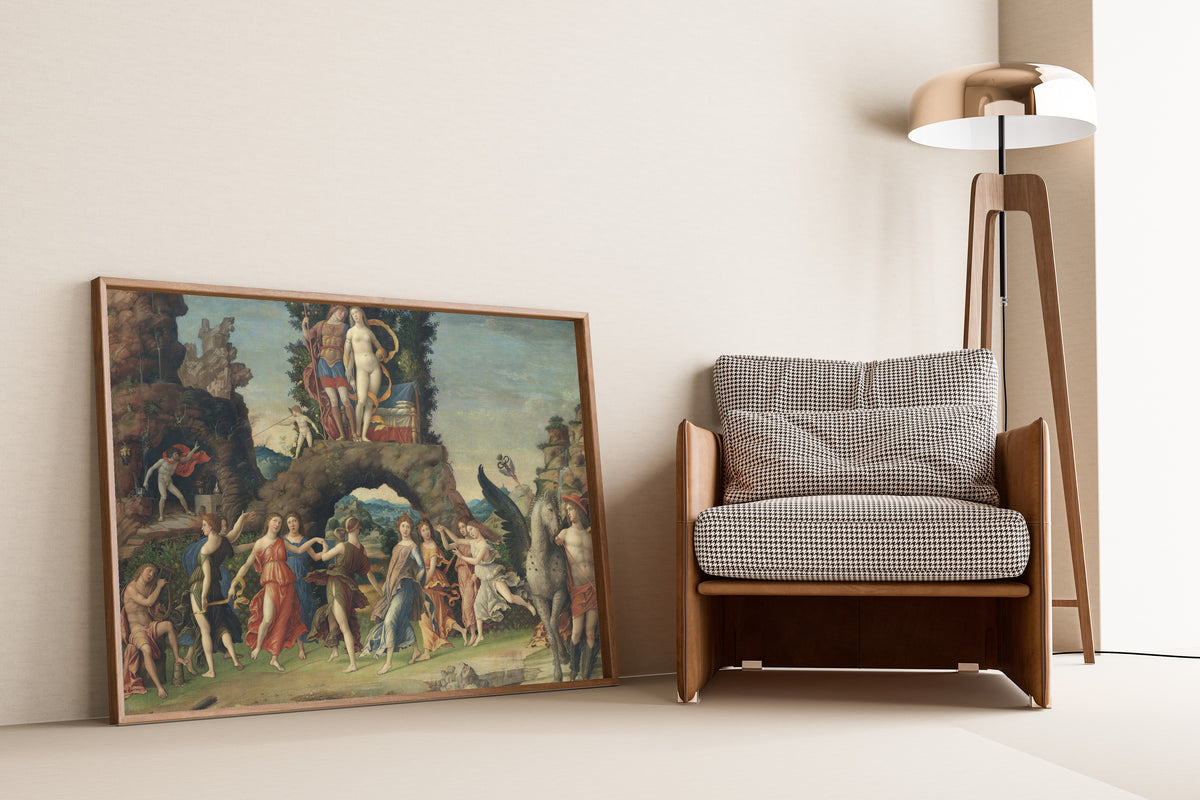 Framed art print of Parnassus by Andrea Mantegna, leaning against a wall beside an armchair and a floor lamp