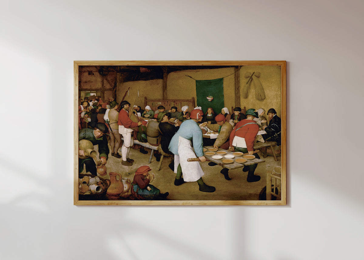 Framed art print of Peasant Wedding by Pieter Bruegel the Elder, in a light wood frame on a sunlit white wall