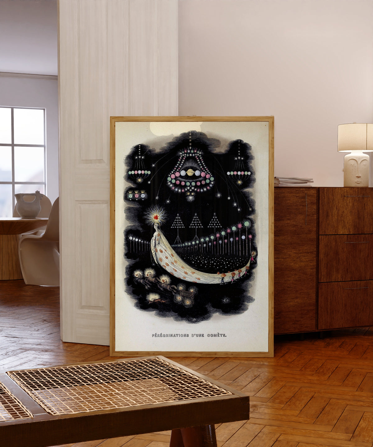 Framed art print of Peregrinations d'une comete by J. J. Grandville, in a light wood frame leaning in a warm room with a parquet floor