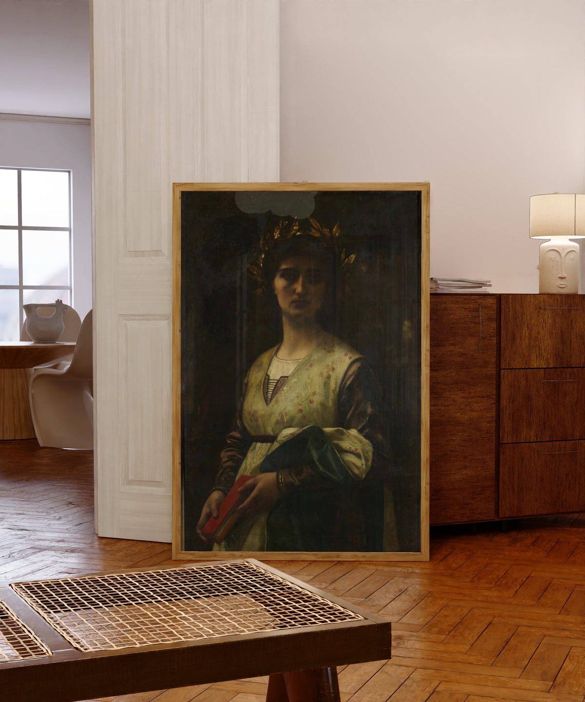 Framed art print of Petrarch's Laura by Alexandre Cabanel, in a light wood frame leaning in a warm room with a parquet floor