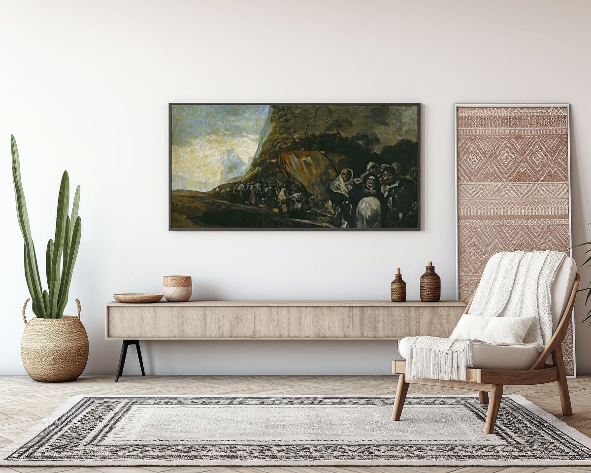 Framed art print of Pilgrimage to the Fountain of San Isidro by Francisco de Goya, above a sideboard in a living room