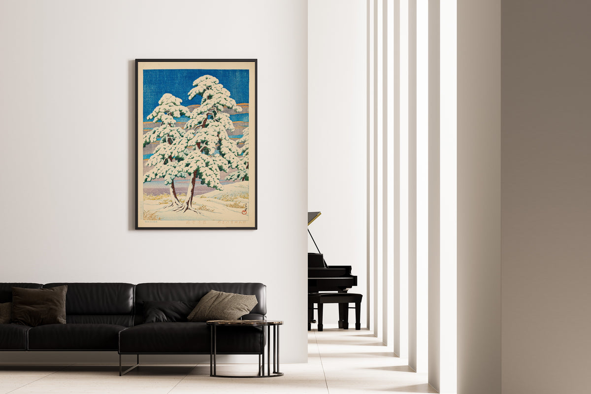 Framed art print of Pines in Clear Weather After Snow by Kawase Hasui, on the wall of a minimal living room