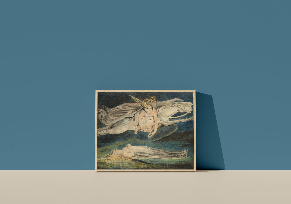 Framed art print of Pity by William Blake, in a light wood frame leaning on a blue wall
