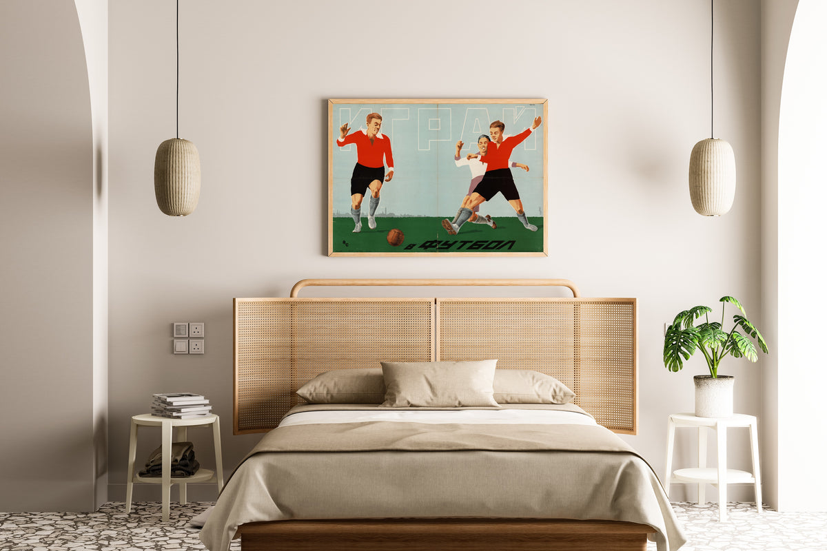 Framed art print of Play Football, above a cane-headboard bed