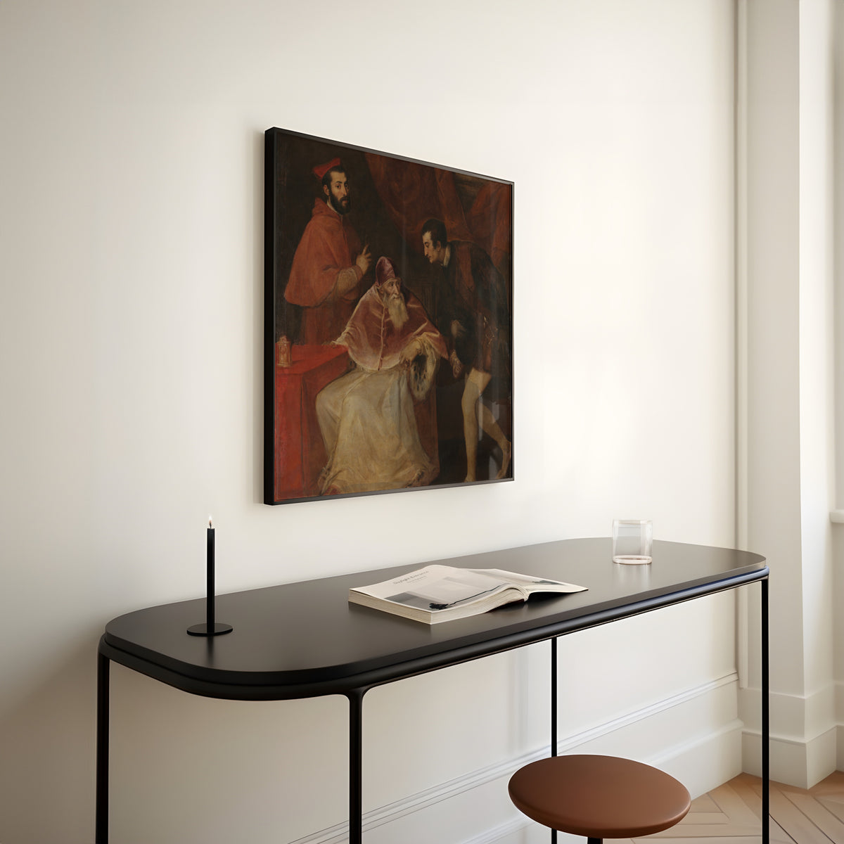 Framed art print of Pope Paul III and His Grandsons by Titian, above a slim black console table