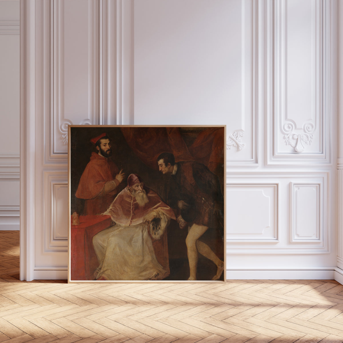 Framed art print of Pope Paul III and His Grandsons by Titian, leaning against pale pink panelling on a herringbone floor