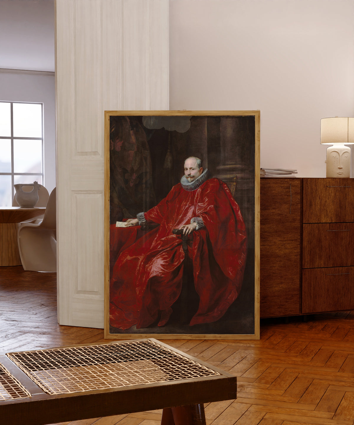 Framed art print of Portrait of Agostino Pallavicini by Anthony van Dyck, in a light wood frame leaning in a warm room with a parquet floor
