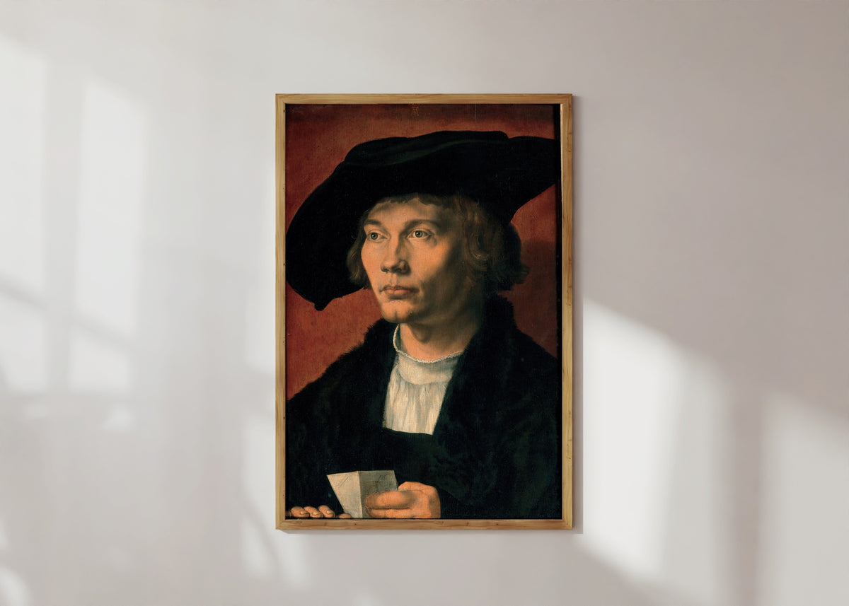 Framed art print of Portrait of Bernhart von Reesen by Albrecht Dürer, in a light wood frame on a sunlit white wall
