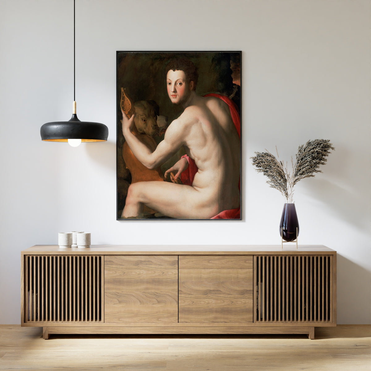 Framed art print of Portrait of Cosimo I de’ Medici as Orpheus by Bronzino, above a slatted wood sideboard