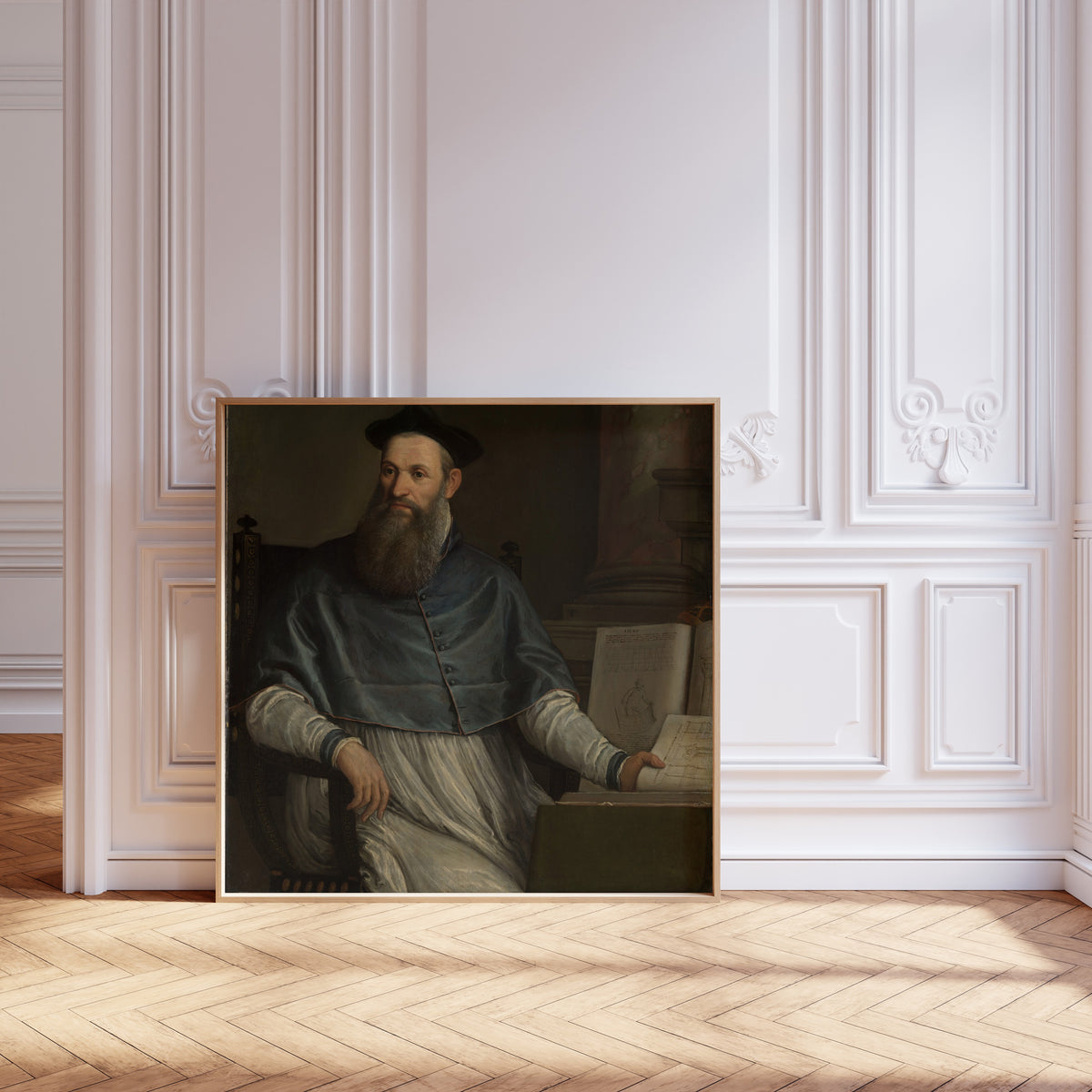 Framed art print of Portrait of Daniele Barbaro by Paolo Veronese, leaning against pale pink panelling on a herringbone floor