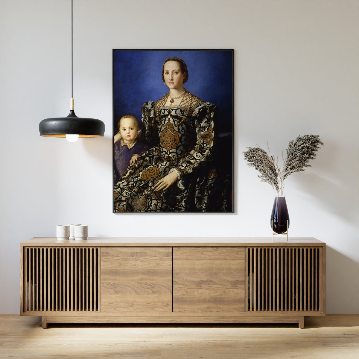 Framed art print of Portrait of Eleanor of Toledo with Her Son Giovanni de’ Medici by Bronzino, above a slatted wood sideboard
