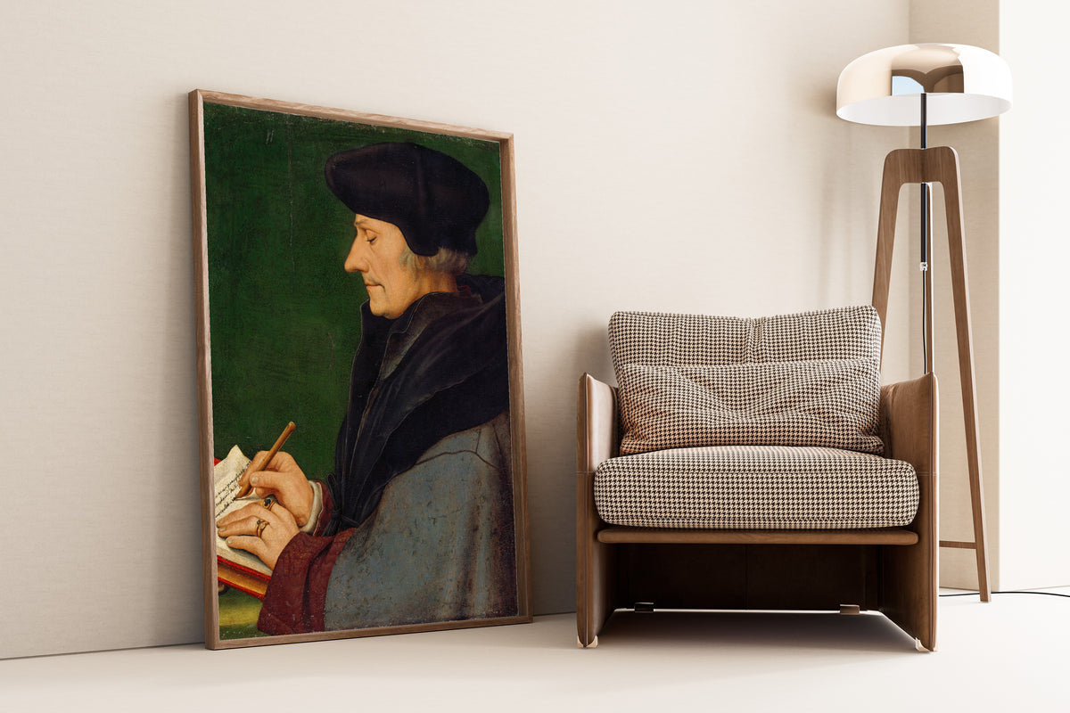 Framed art print of Portrait of Erasmus of Rotterdam Writing by Hans Holbein the Younger, leaning against a wall beside an armchair and a floor lamp
