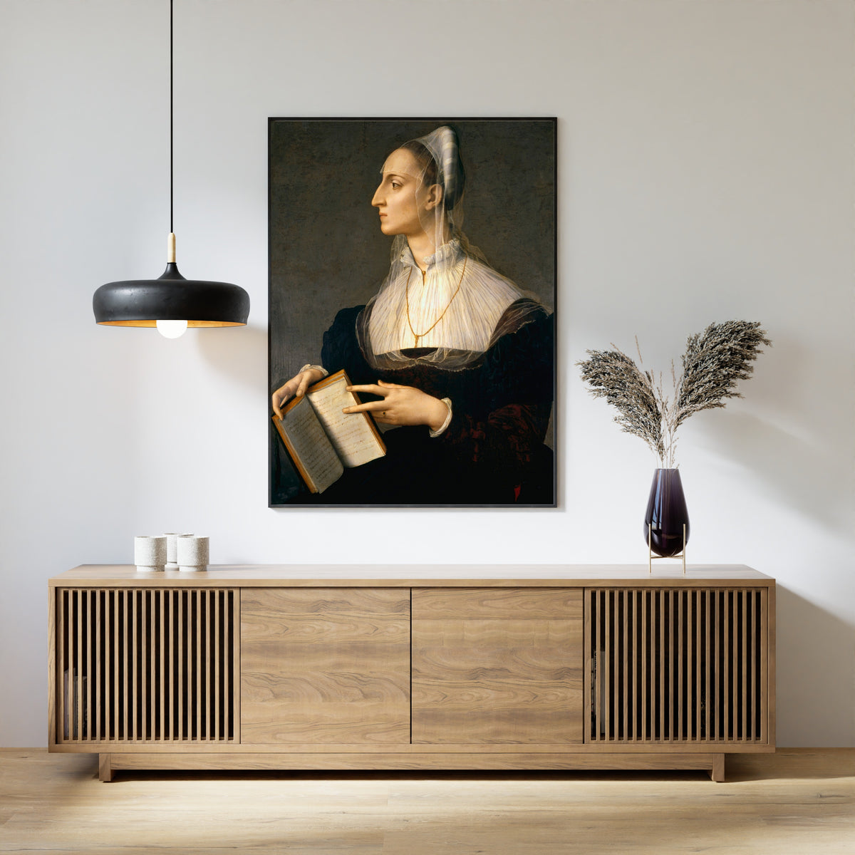 Framed art print of Portrait of Laura Battiferri by Bronzino, above a slatted wood sideboard