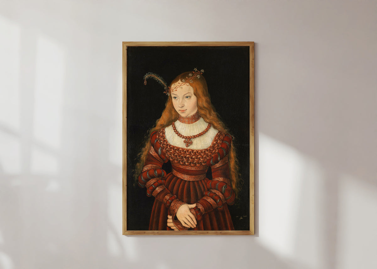 Framed art print of Portrait of Princess Sibylle of Cleves by Lucas Cranach the Elder, in a light wood frame on a sunlit white wall