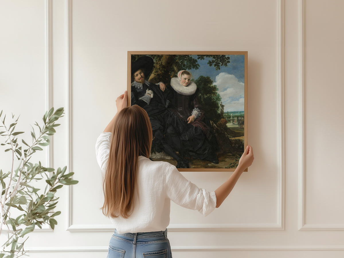 Framed art print of Portrait of a Couple, Probably Isaac Abrahamsz Massa and Beatrix van der Laen by Frans Hals, hung on a panelled wall