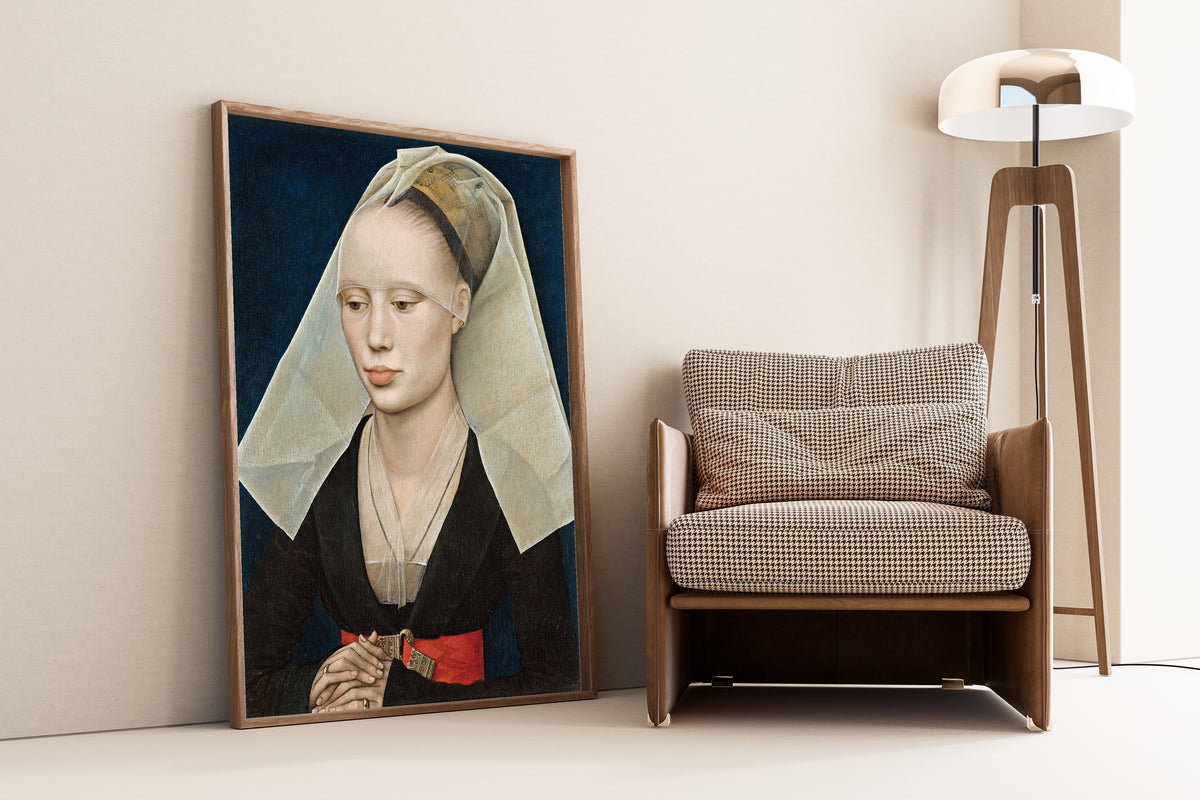 Framed art print of Portrait of a Lady by Rogier van der Weyden, leaning against a wall beside an armchair and a floor lamp