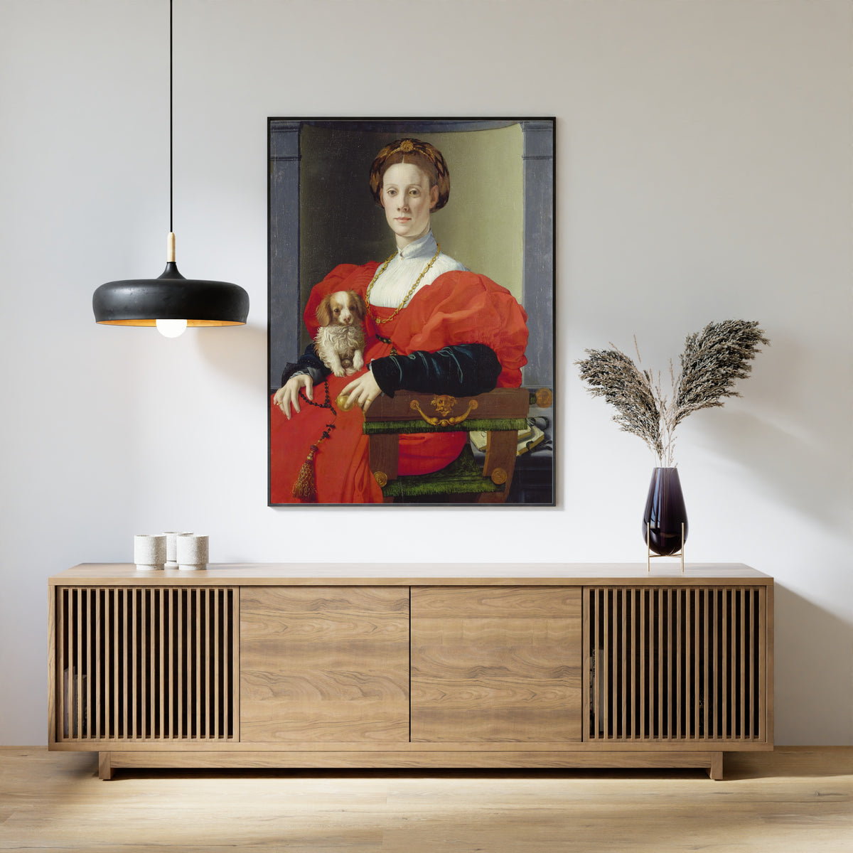 Framed art print of Portrait of a Lady in Red (Francesca Salviati) by Bronzino, above a slatted wood sideboard