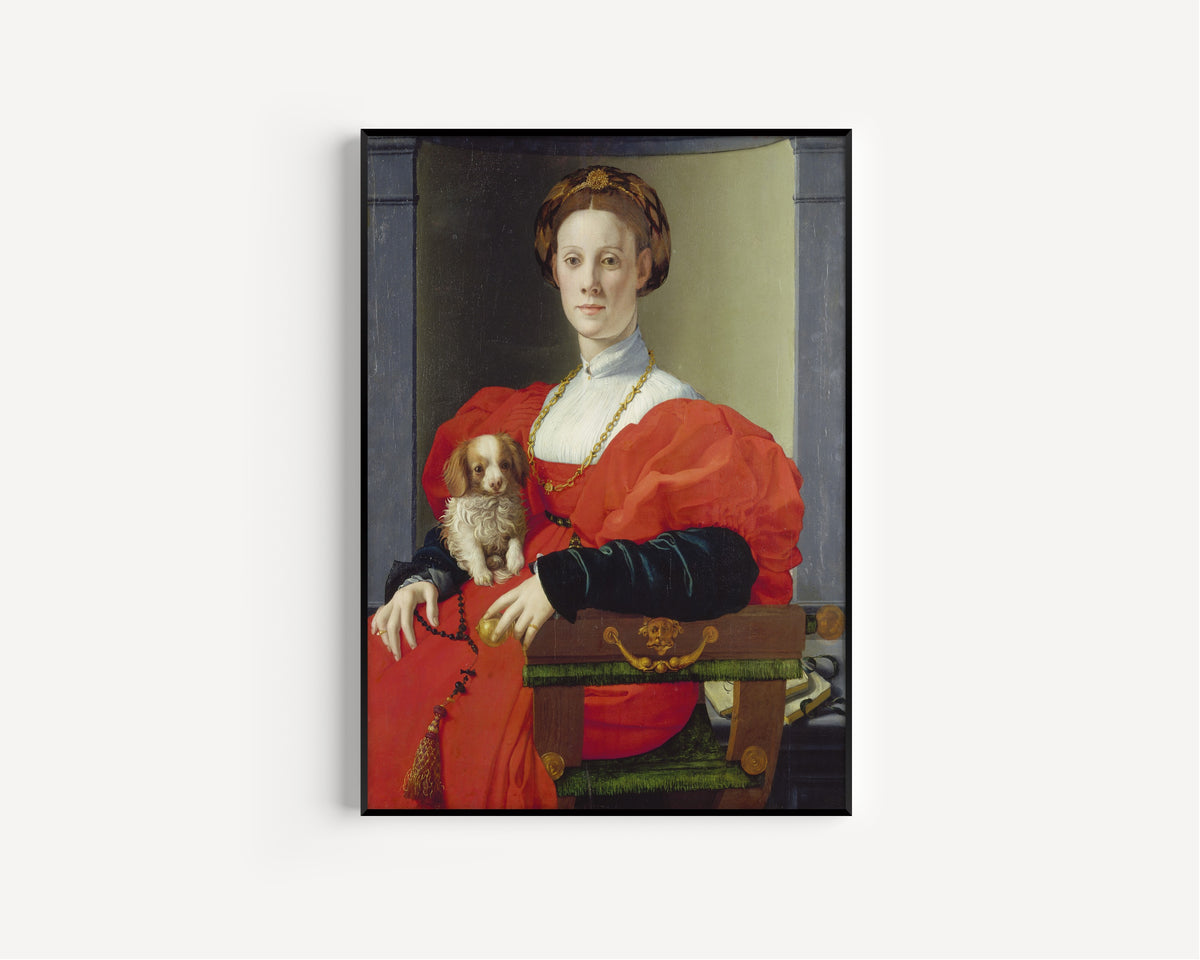 Framed art print of Portrait of a Lady in Red (Francesca Salviati) by Bronzino, in a slim black frame on a plain white wall
