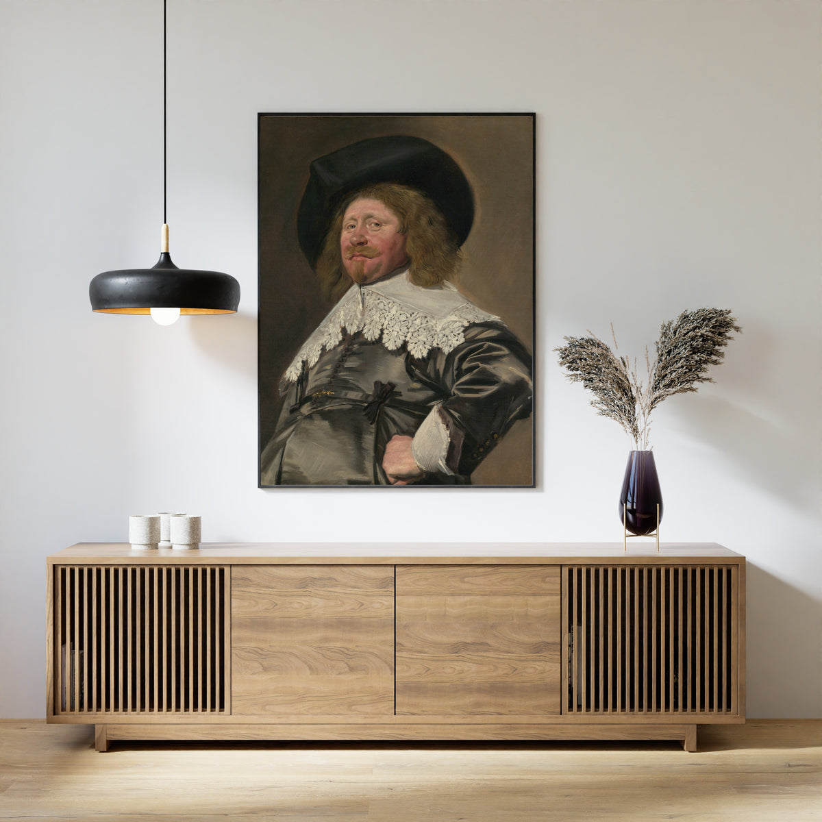 Framed art print of Portrait of a Man, Possibly Nicolaes Pietersz Duyst van Voorhout by Frans Hals, above a slatted wood sideboard