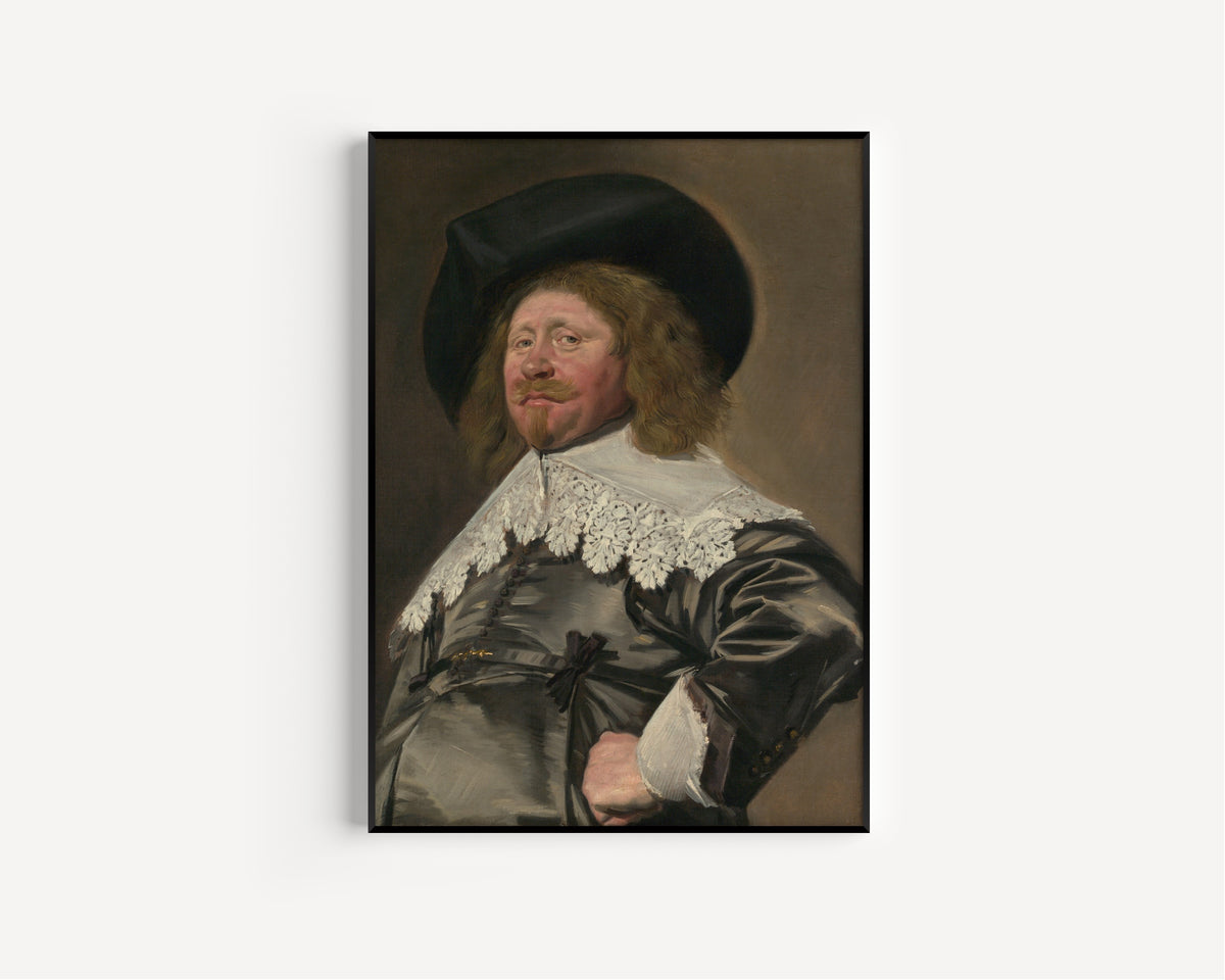 Framed art print of Portrait of a Man, Possibly Nicolaes Pietersz Duyst van Voorhout by Frans Hals, in a slim black frame on a plain white wall
