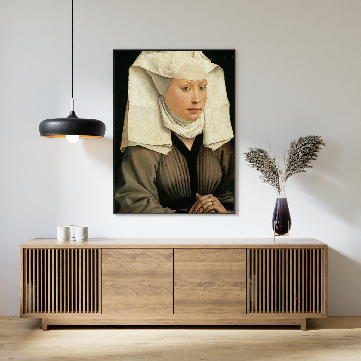 Framed art print of Portrait of a Woman by Rogier van der Weyden, above a slatted wood sideboard