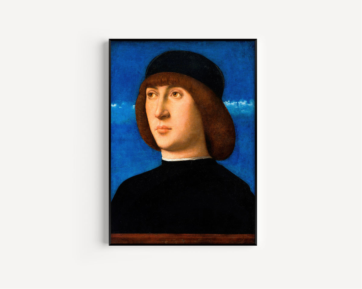 Framed art print of Portrait of a Young Man by Giovanni Bellini, in a slim black frame on a plain white wall