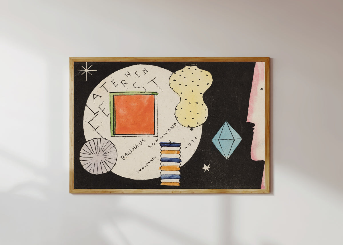 Framed art print of Postcard invitation to a lantern festival by Oskar Schlemmer, in a light wood frame on a sunlit white wall