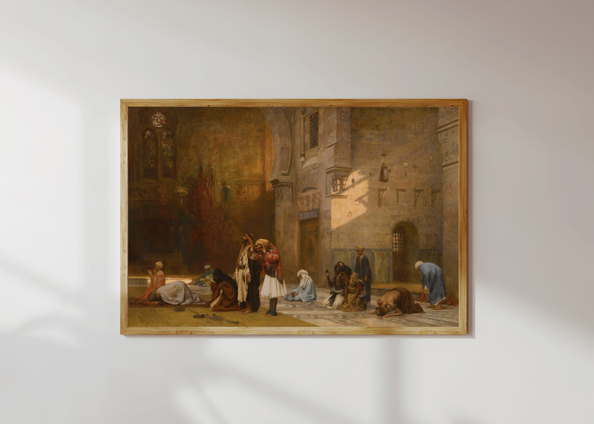 Framed art print of Prayer in the Mosque, Cairo by Frederick Arthur Bridgman, in a light wood frame on a sunlit white wall