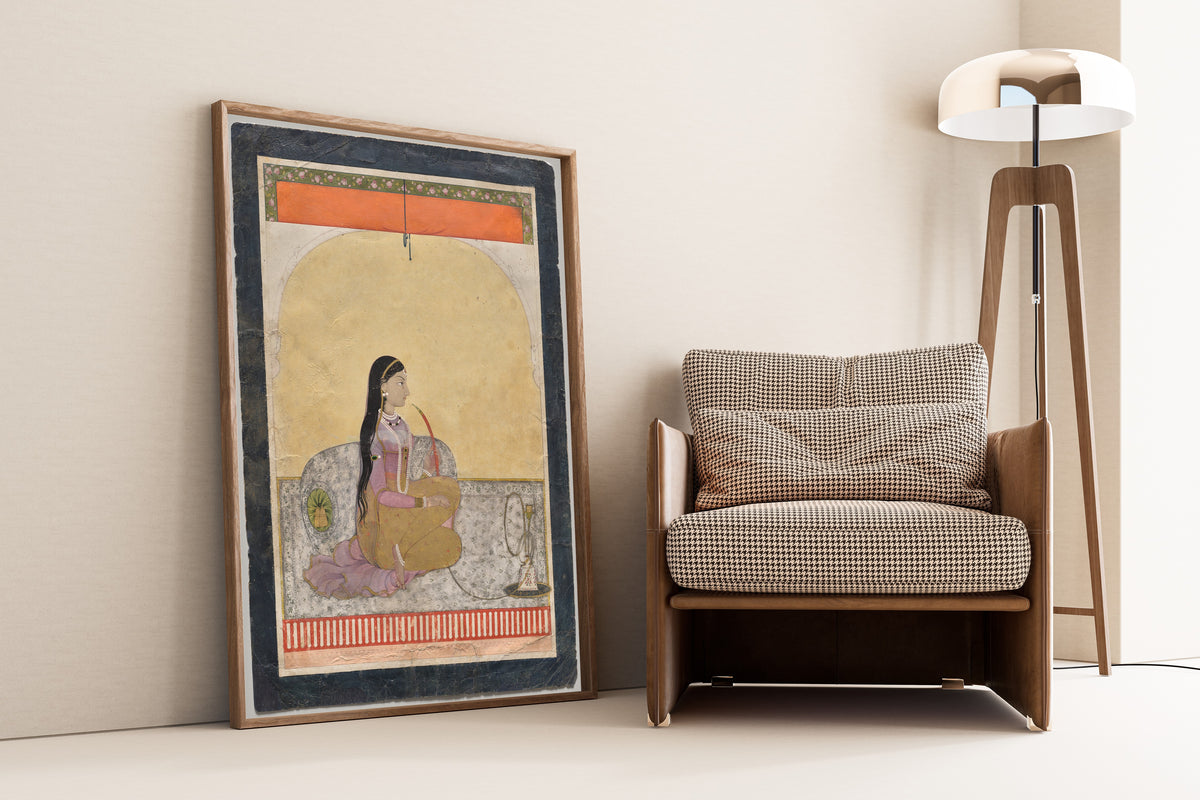 Framed art print of Princess Smoking a Hookah by Pahari school, leaning against a wall beside an armchair and a floor lamp