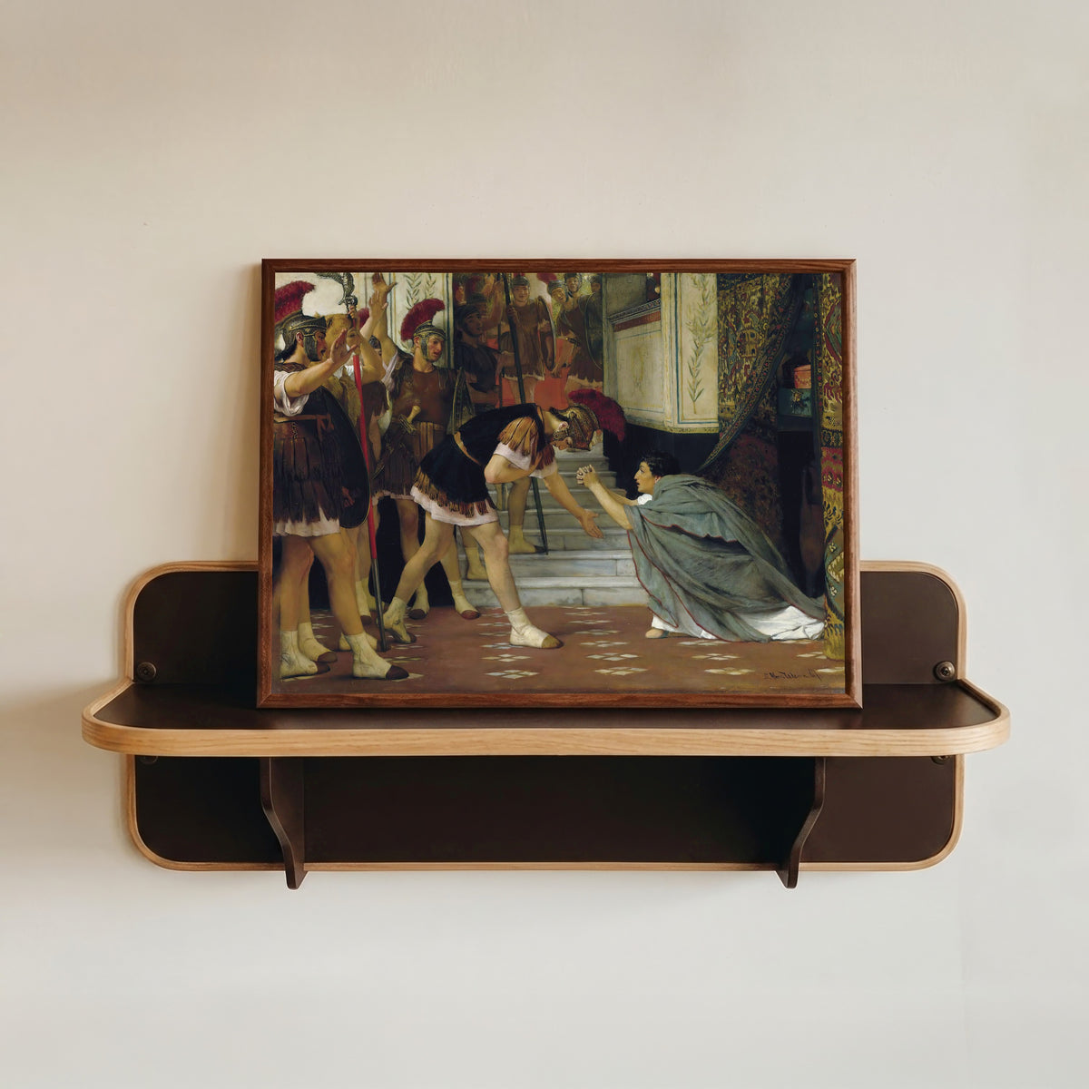 Framed art print of Proclaiming Claudius Emperor by Lawrence Alma-Tadema, in a dark wood frame resting on a wall shelf