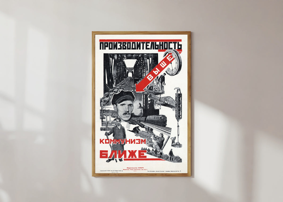 Framed art print of Productivity higher, communism closer, in a light wood frame on a sunlit white wall