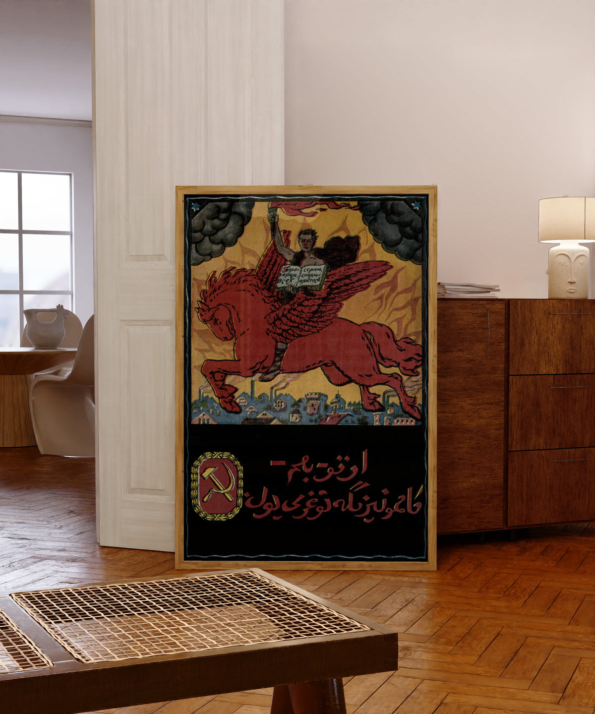 Framed art print of Proletarians of all countries, unite!, in a light wood frame leaning in a warm room with a parquet floor
