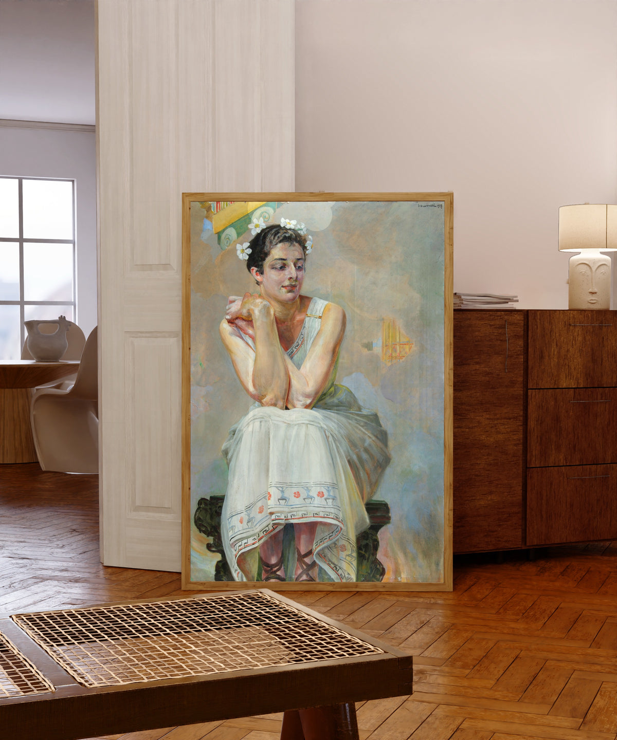 Framed art print of Pythia by Jacek Malczewski, in a light wood frame leaning in a warm room with a parquet floor