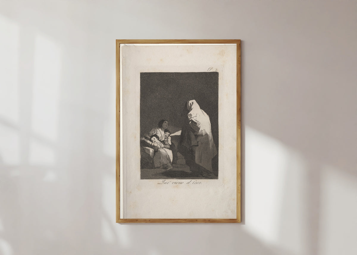 Framed art print of Que viene el Coco (Here Comes the Bogeyman), Los Caprichos, Plate 3 by Francisco de Goya, in a light wood frame on a sunlit white wall
